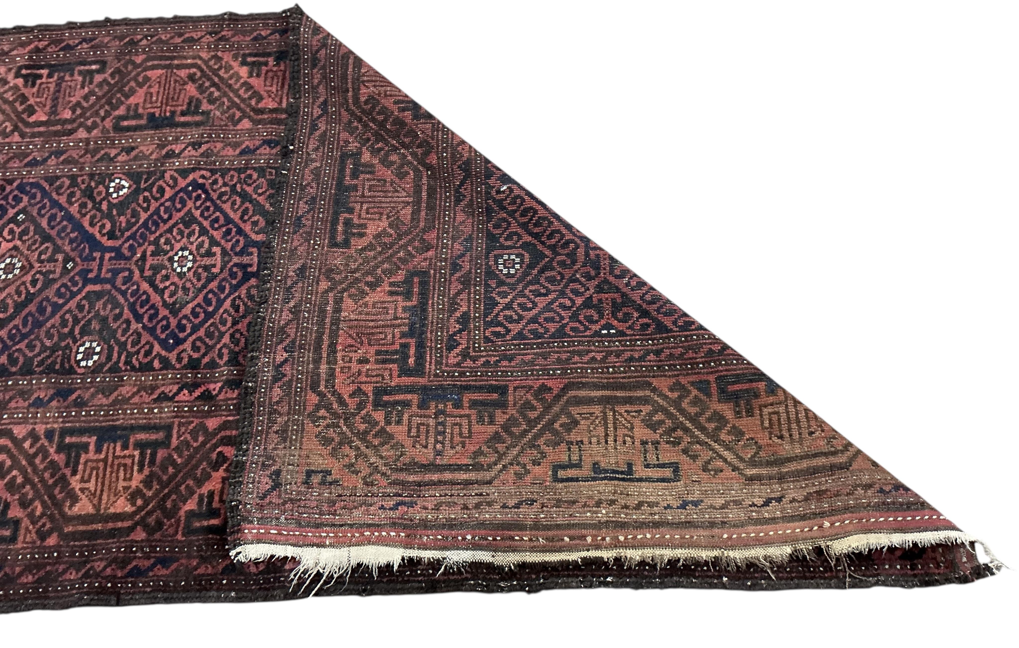 Two Belouch tribal rugs and an Afghan tribal rug, largest 200 x 110cm